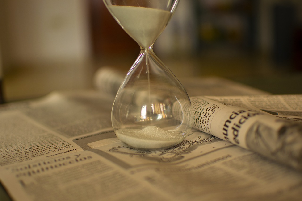 An hourglass on a wooden table symbolizing the statute of limitations deadline.
