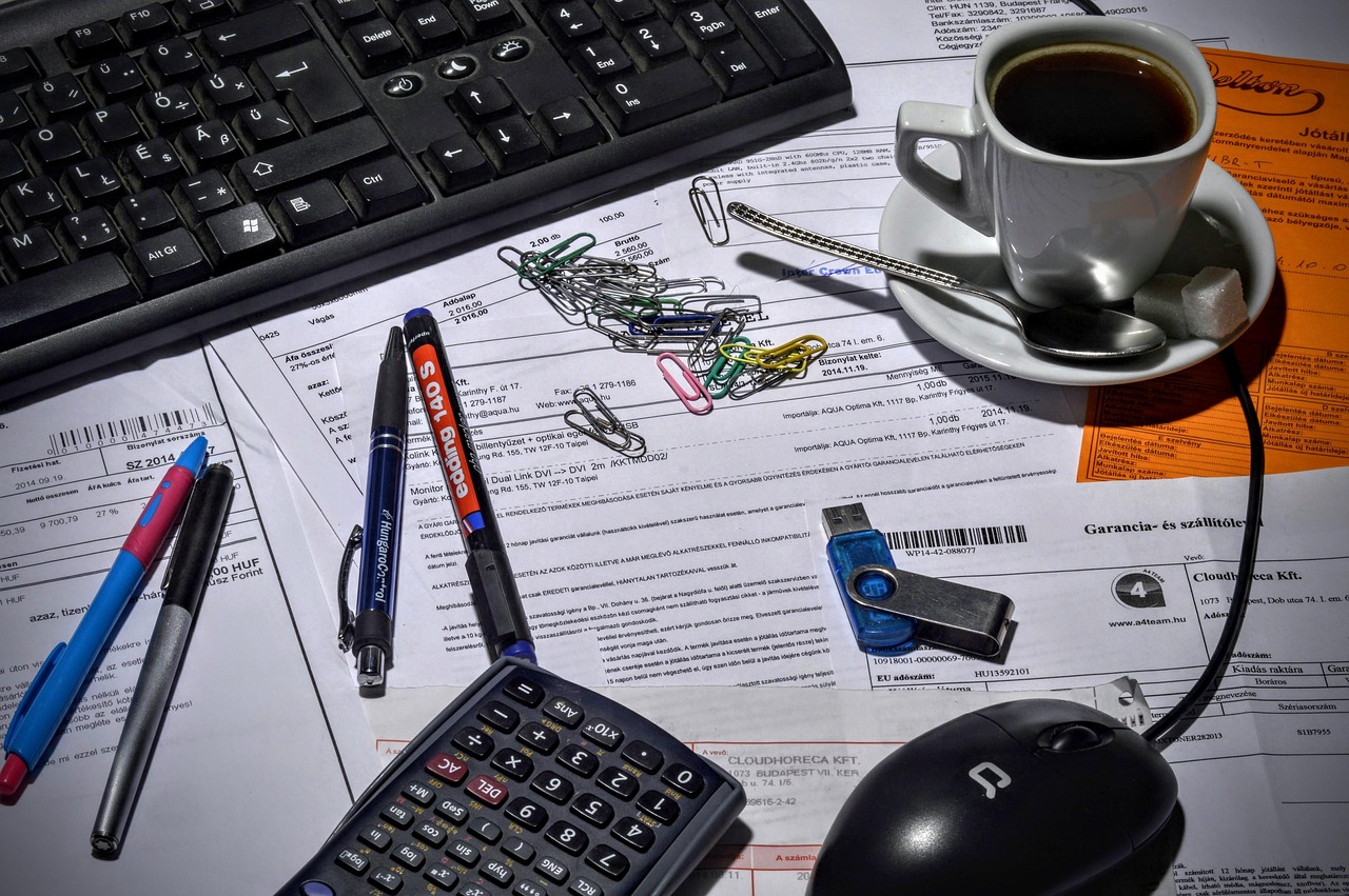A neat desk setup with financial paperwork and a modern calculator.