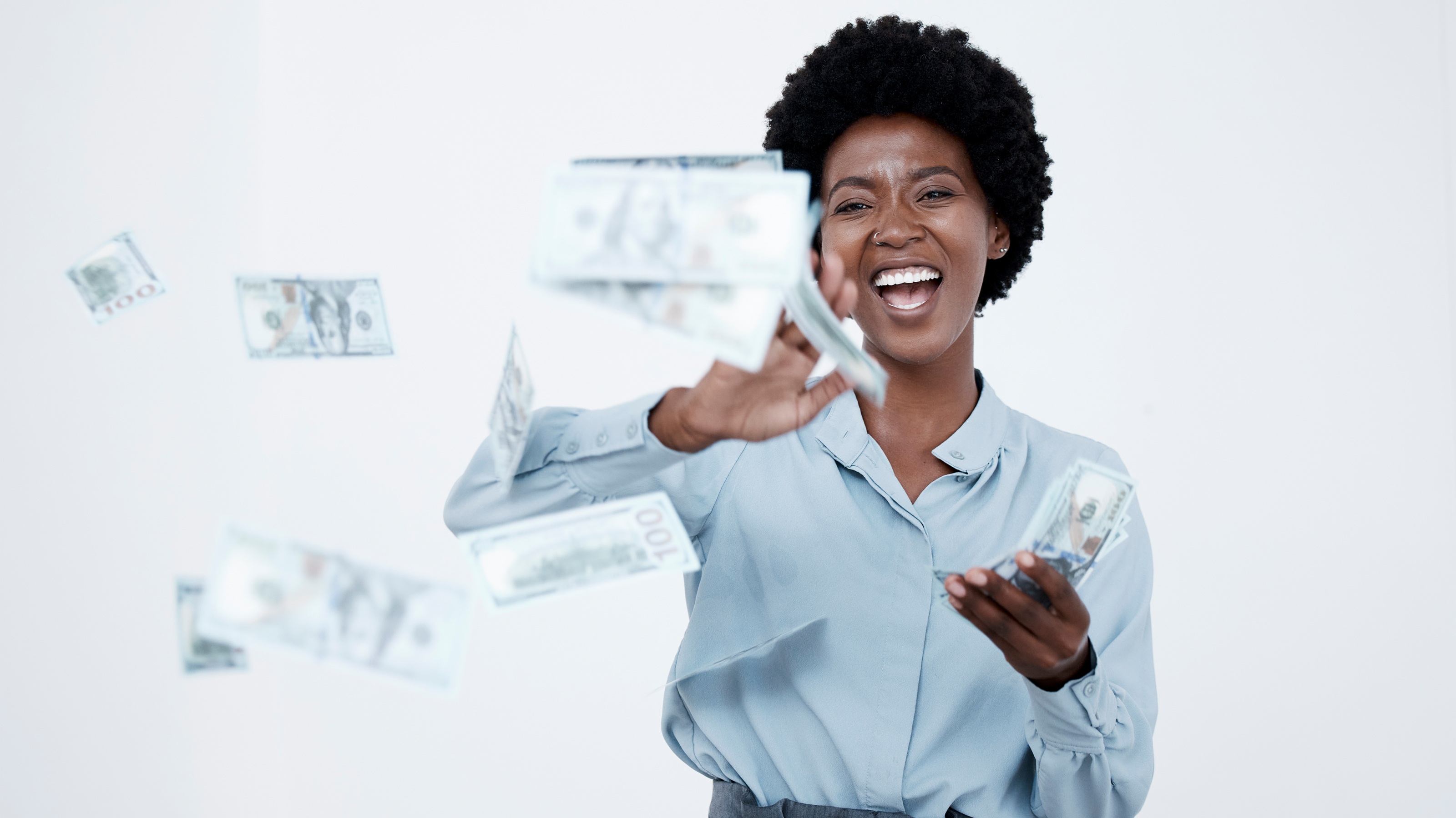 A woman celebrating financial freedom and the successful management of her wealth.
