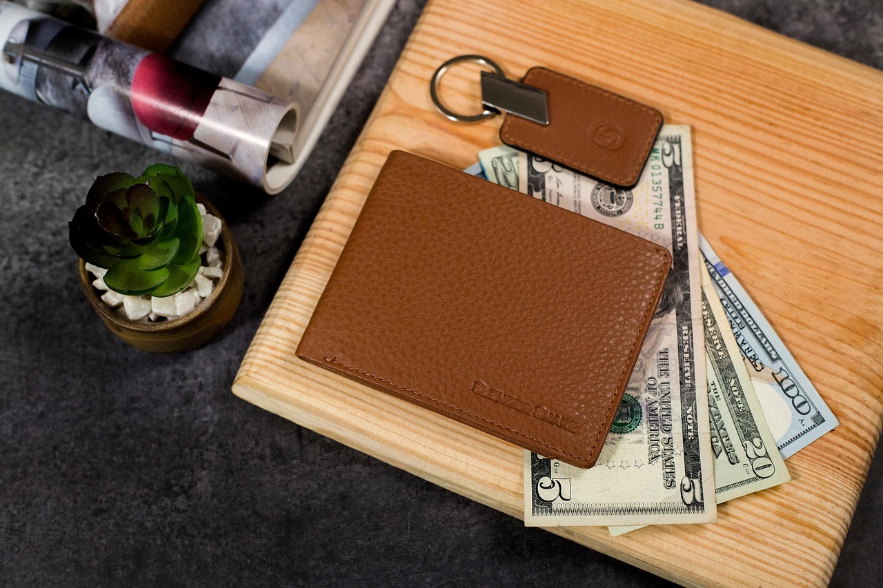 A padlock and chain wrapped around a wallet representing frozen financial assets.