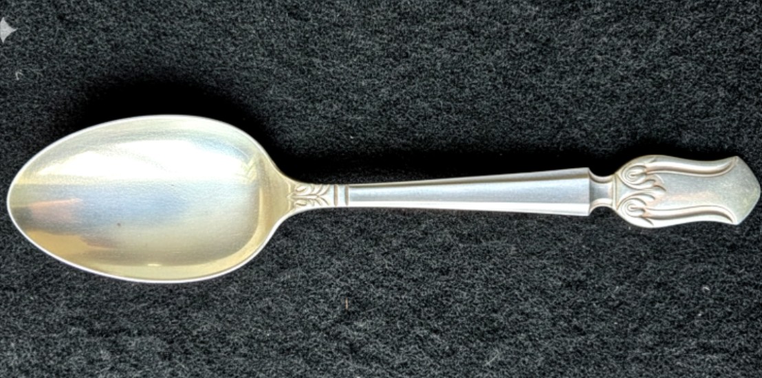 A single antique sterling silver spoon manufactured in 1937.