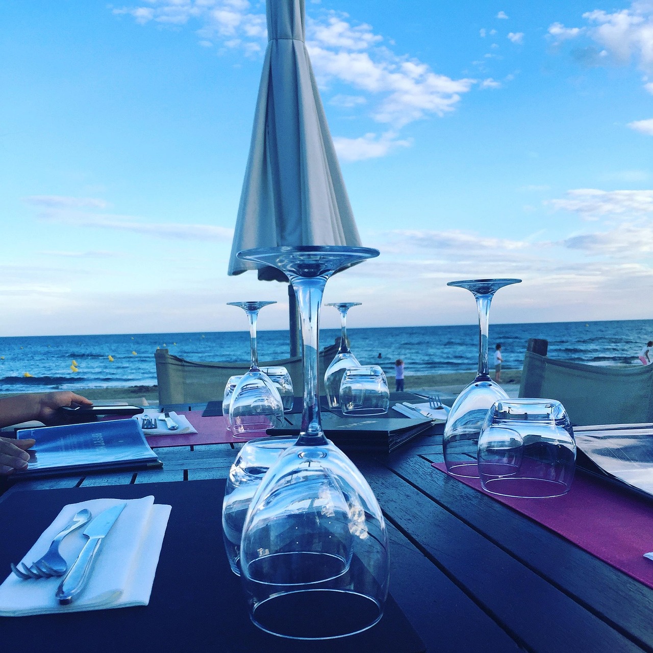 A beautifully set table at a high-end restaurant representing the Resy dining credit.