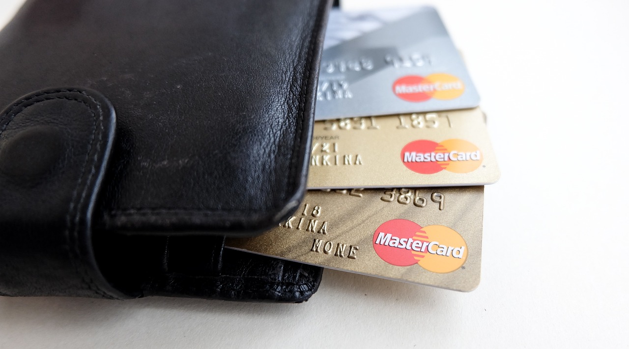 A close-up of a contactless credit card payment at a retail merchant terminal.