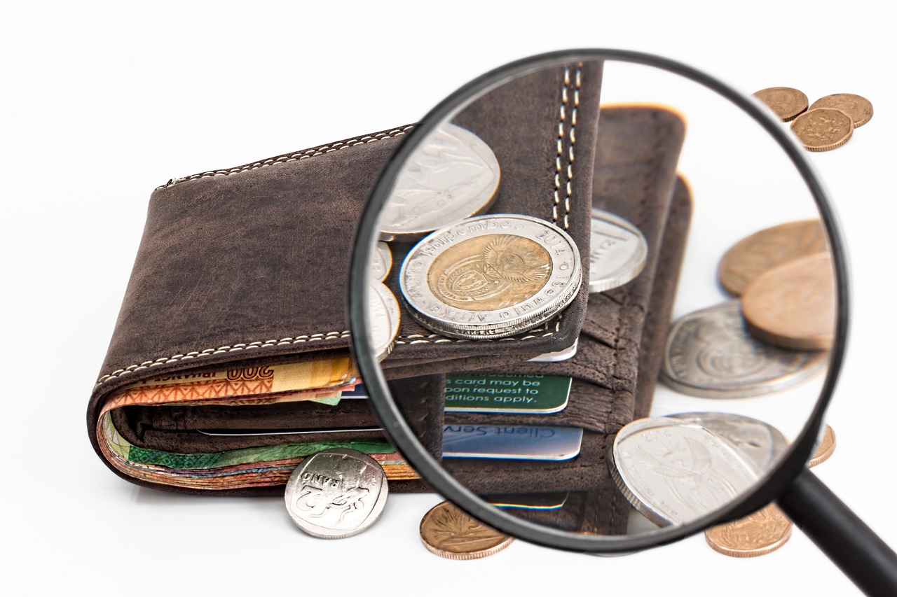 A magnifying glass focusing on line items of a financial audit report.