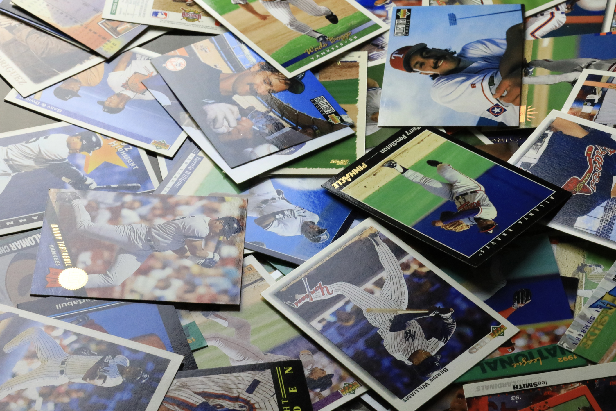 Various vintage baseball cards scattered across a wooden surface.