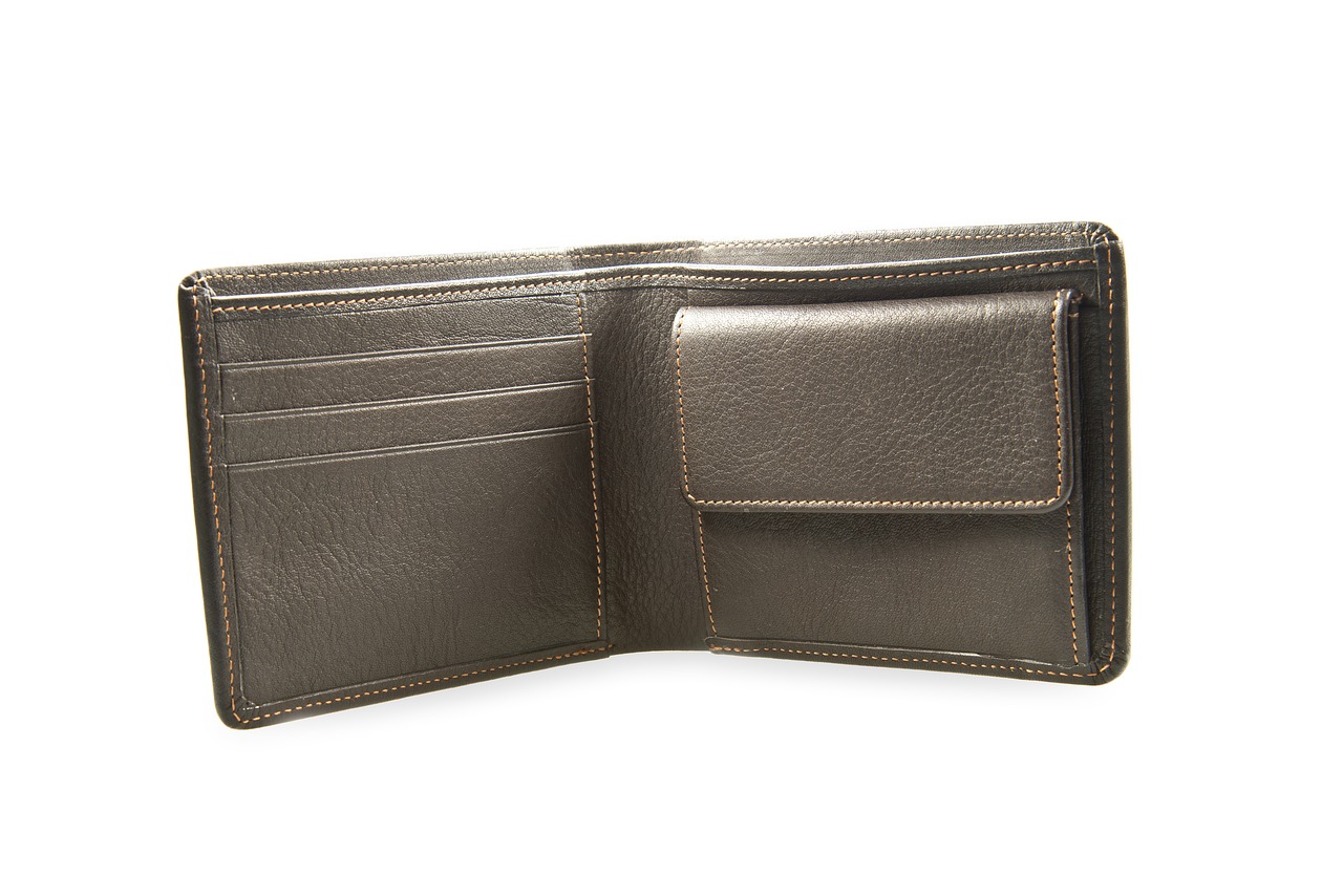 A luxury leather wallet and gold accents representing high-value financial strategy.