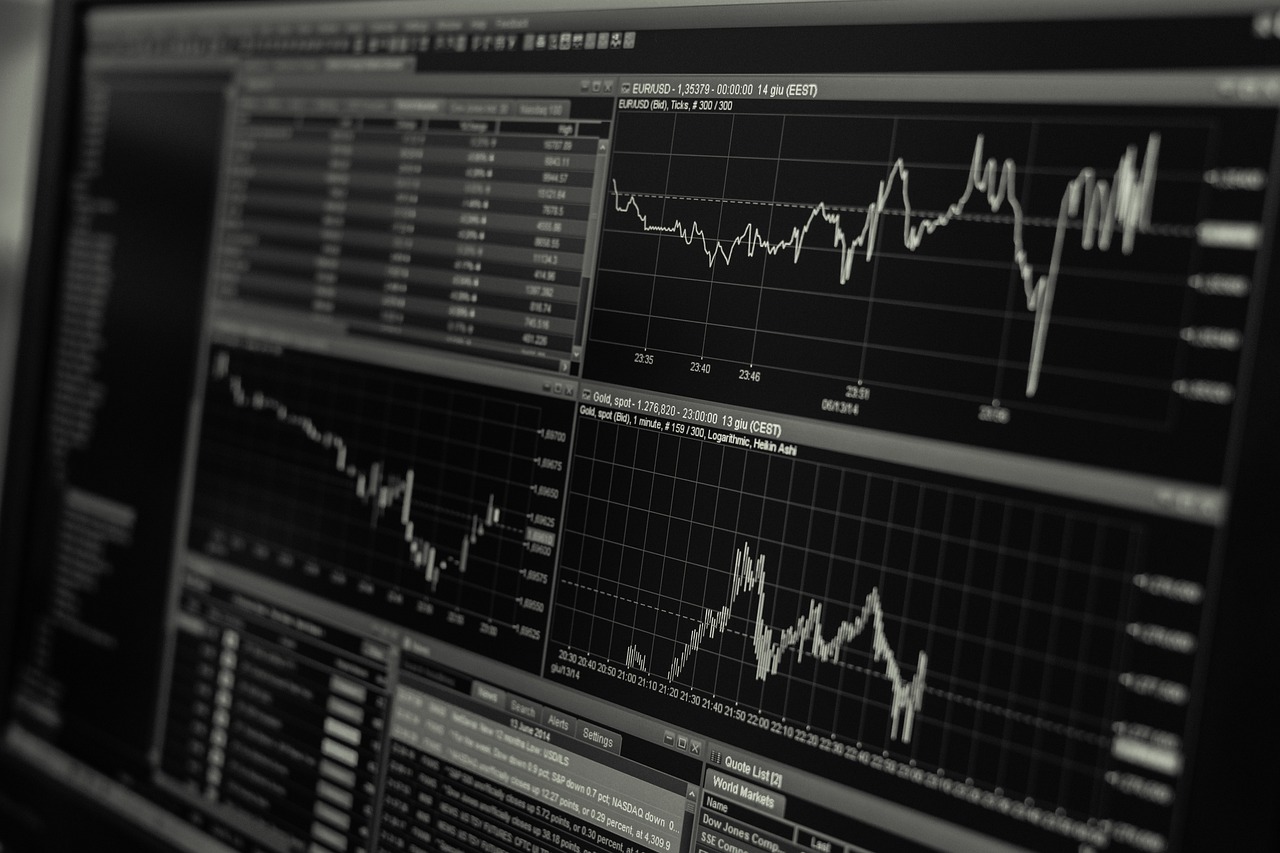 A digital screen showing a green upward-trending arrow and various financial bar graphs.