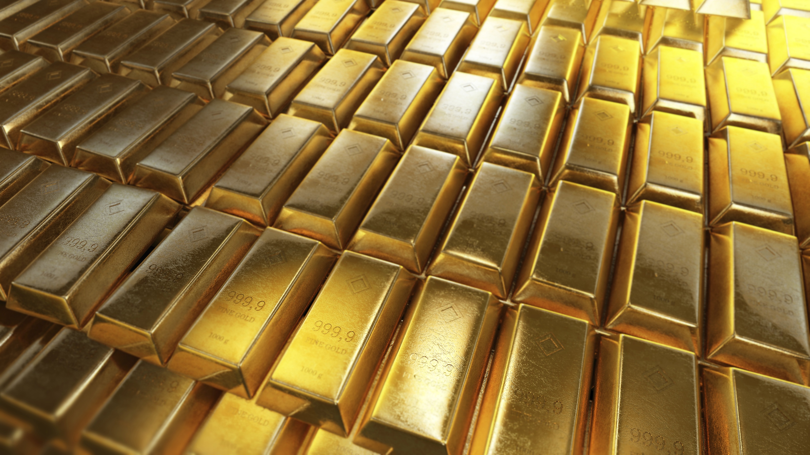 Multiple rows of shiny gold bars stacked together.