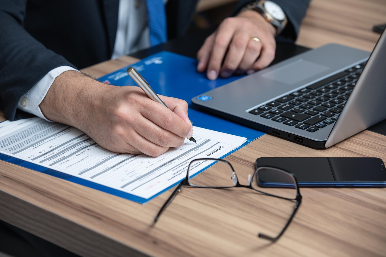 A person looking concerned while reading a formal court summons at a desk.