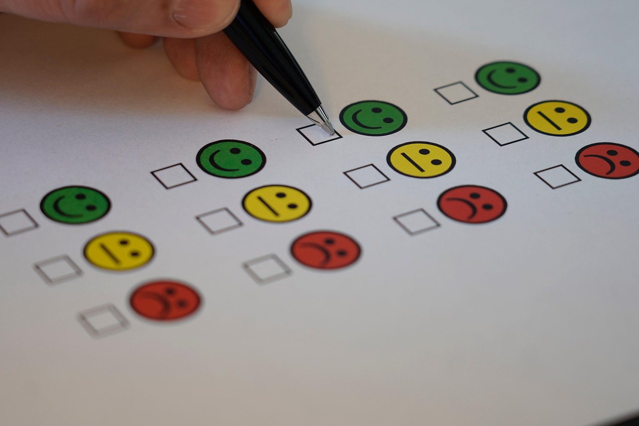 A checklist on a wooden desk with a pen and a set of new house keys.