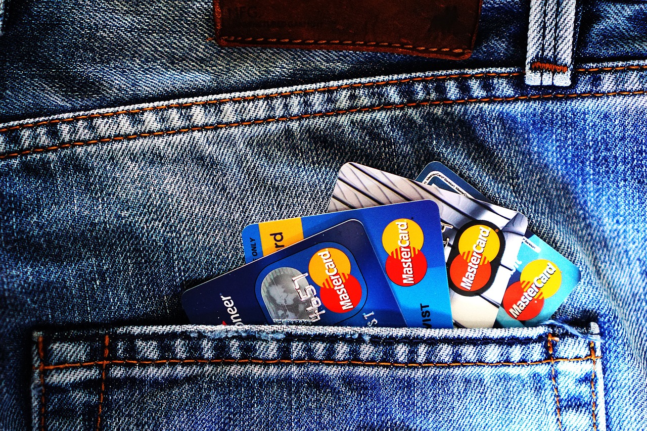 A close up of a modern blue credit card on a reflective surface