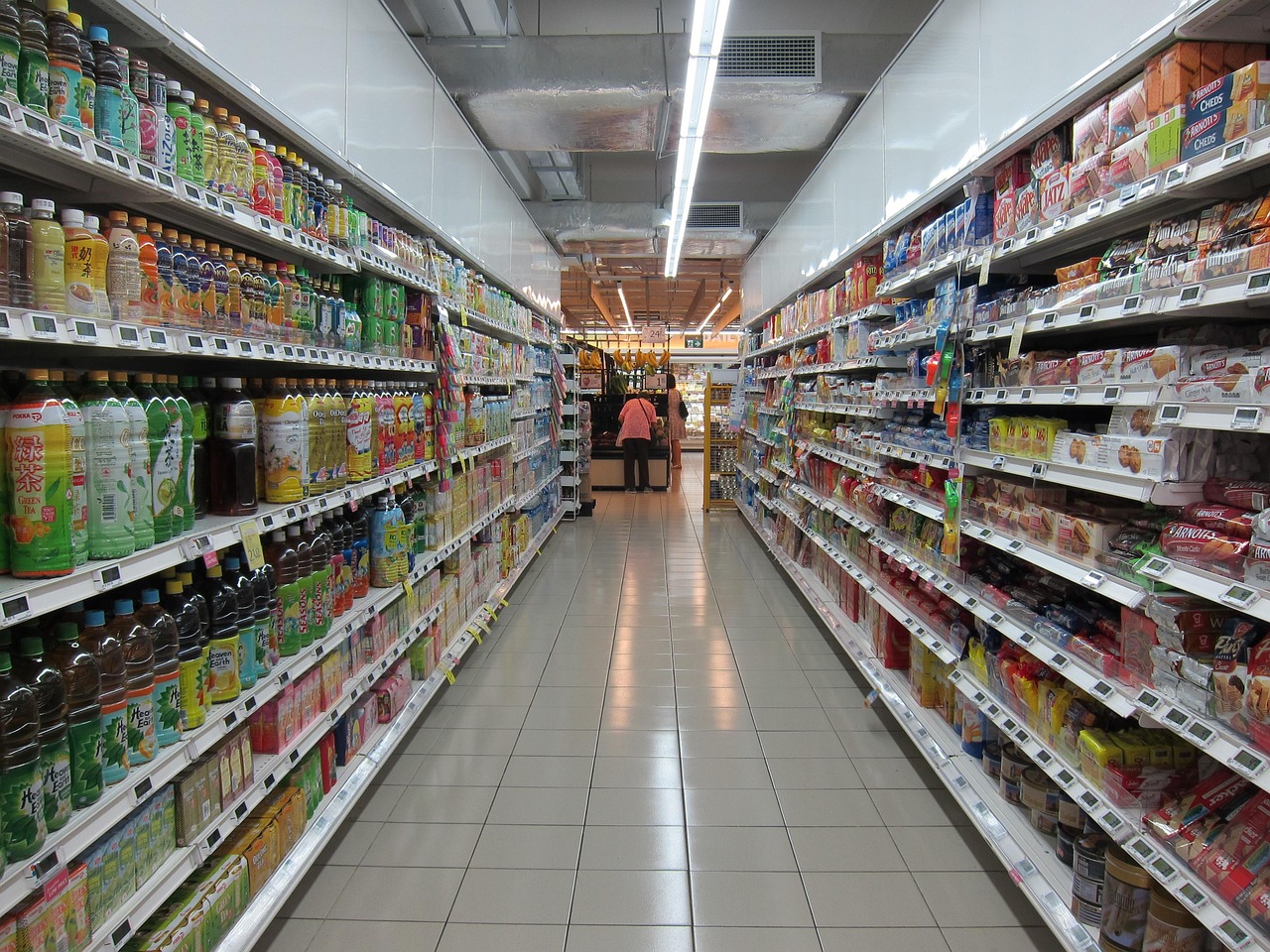 Rows of products on shelves in a grocery store aisle.