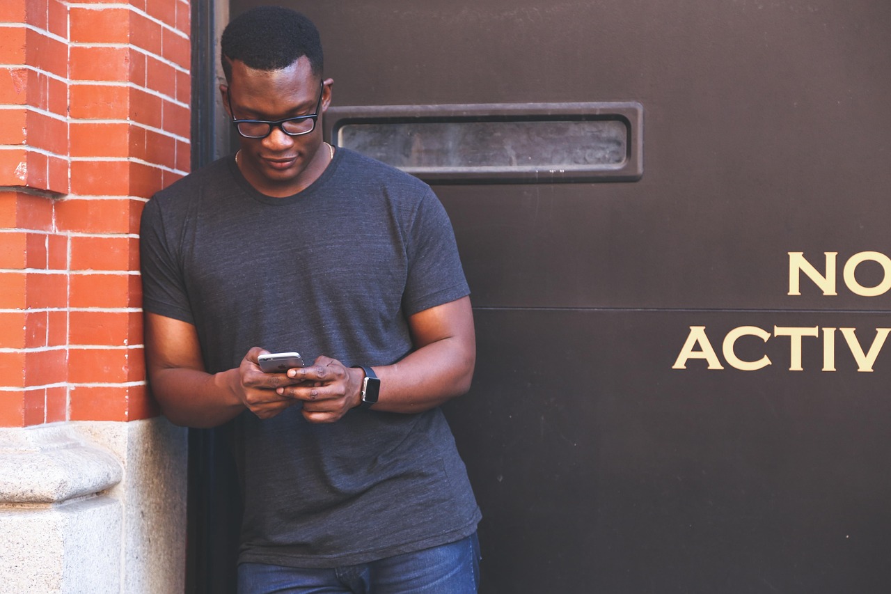 A person comfortably managing their savings account using a mobile phone.