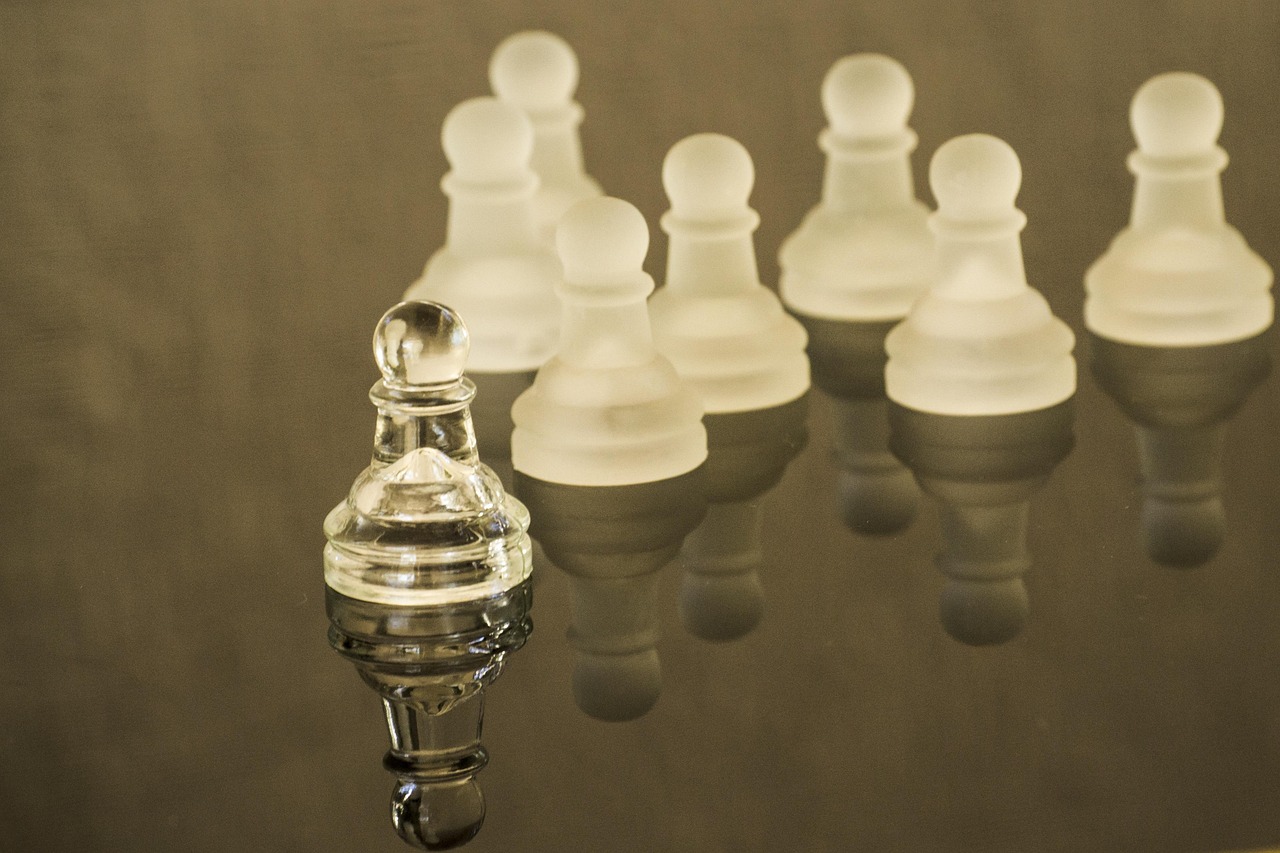 A person playing chess with a focus on one specific piece move