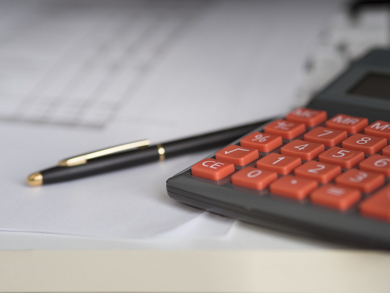 Organized piles of receipts and a calculator for business expense tracking