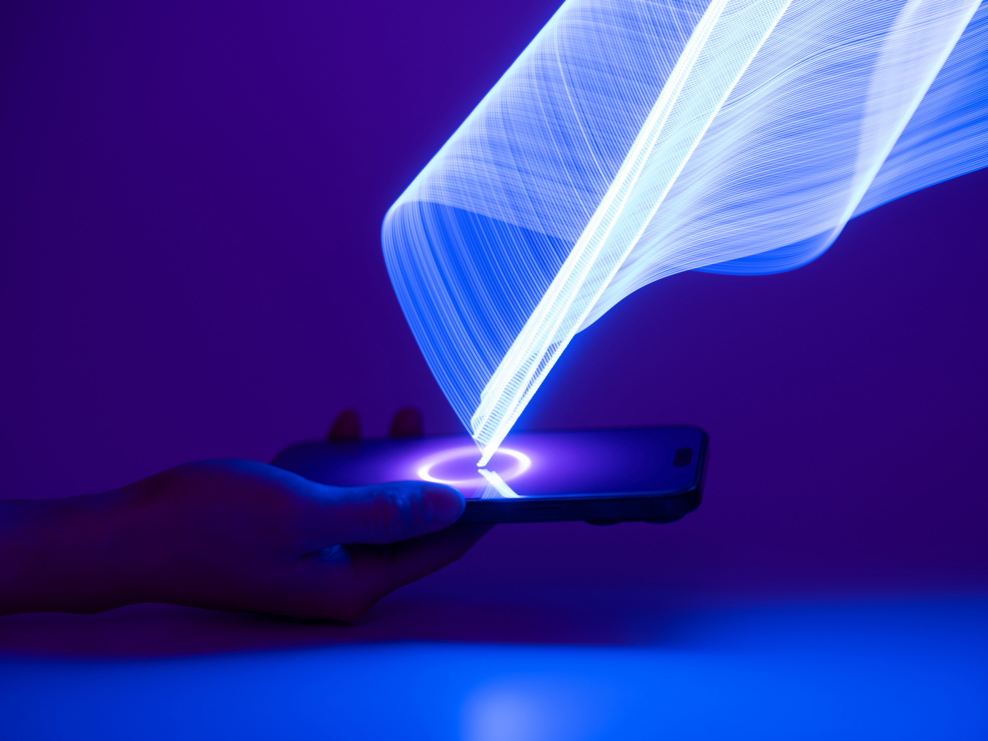 A close-up of a hand holding a glowing smartphone, symbolizing a modern fintech ecosystem.
