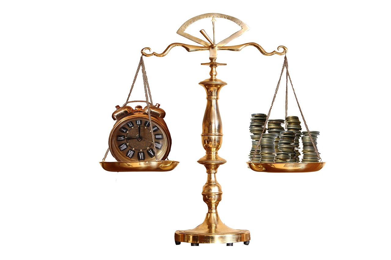 A balanced scale with different types of coins representing the choice between IRA account types.