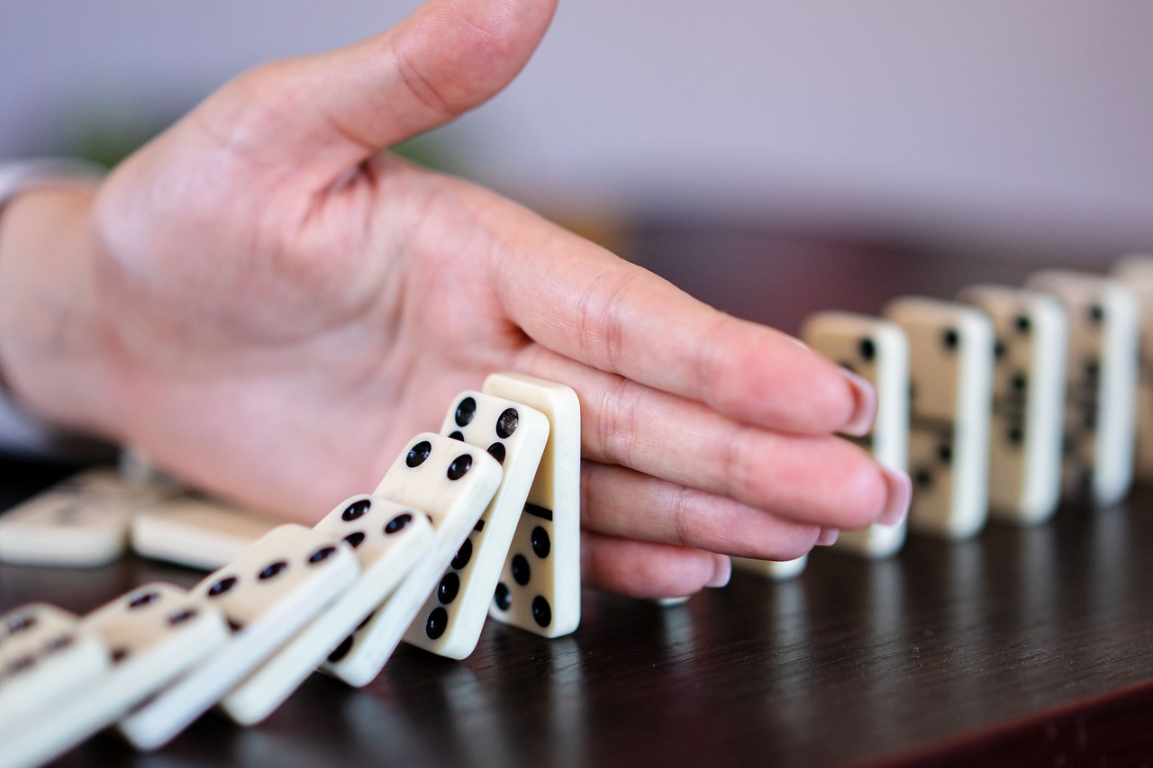 Hands assembling puzzle pieces representing financial components coming together