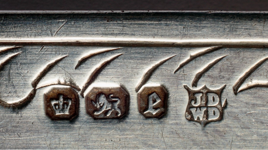 Close-up of 1897 British silver hallmarks including the lion passant and maker's marks.